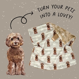 May include: A light gray blanket with a repeating pattern of a brown dog and the text "MURPHY + ME". The blanket has a faux fur trim and the text "TURN YOUR PETS INTO A LOVEY!"