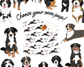 May include: A white blanket with a brown satin trim featuring a repeating pattern of a dog and the text "ROCKY + ME". The image also includes various dog illustrations and the phrase "Choose your own pup!"