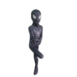 May include: A black and white Spider-Man costume. The full-body suit has a web pattern and a large spider emblem on the chest. The mask has white eye lenses. The costume covers the entire body, including the head and feet.