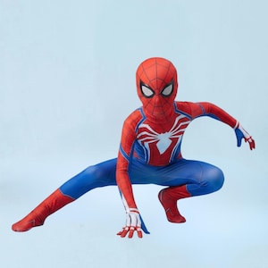 May include: A full-body spandex costume featuring a red and blue color scheme with a black web pattern. The suit includes a matching mask with white eye lenses and a large white spider emblem centered on the chest, designed for a superhero character.