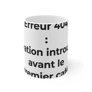May include: A white ceramic mug featuring black text that reads Erreur 404 : motivation introuvable avant le premier café. The mug has a cylindrical shape with a smooth finish and a clean, minimalist design, displaying the French text clearly.