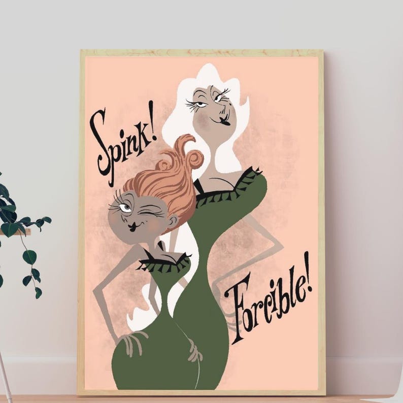May include: A framed art print on a light peach background featuring two stylized figures in green dresses. One figure has reddish-brown hair and is winking, while the other has white hair. The text Spink! and Forcible! is written in black.