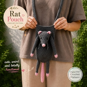May include: A dark gray crochet pouch shaped like a rat with pink accents on the ears, nose, feet, and tail. The pouch features a long strap and includes text that reads Rat Pouch Crochet Pattern, cute, weird and totally functional, Digital PDF.