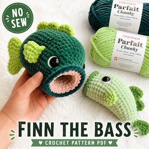 May include: A dark green and light green crochet fish toy with large black safety eyes and a pink interior mouth. Beside it are two skeins of Premier Parfait Chunky yarn in dark green and light green. Text reads NO SEW and FINN THE BASS CROCHET PATTERN PDF.