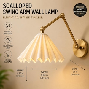 May include: A brass swing arm wall lamp with a pleated off-white fabric shade. The lamp features an adjustable arm and a circular wall mount. Dimensions are 4.96 inches in height, 8.46 inches in width, and 21 inches in total depth.