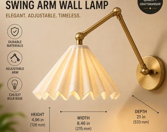 May include: A brass swing arm wall lamp with a pleated off-white fabric shade. The lamp features an adjustable arm and a circular wall mount. Dimensions are 126 mm in height, 215 mm in width, and 533 mm in total depth.
