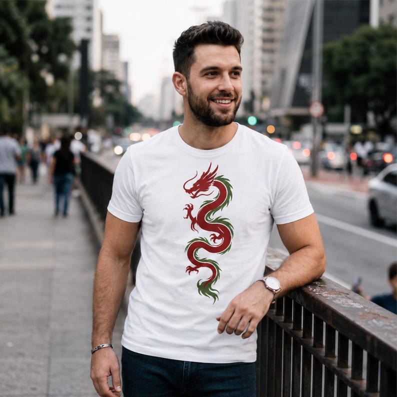 May include: White t-shirt featuring a red and green dragon design. The dragon is depicted in a vertical, stylized manner, with intricate details. The shirt is a classic crew neck style, made of a soft material.