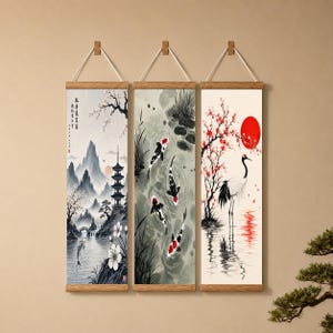 May include: Three vertical wall scrolls featuring ink-style illustrations. The first shows a pagoda, mountains, and a fish. The second depicts four koi fish swimming in water. The third displays a crane standing near a red sun and flowering branches.