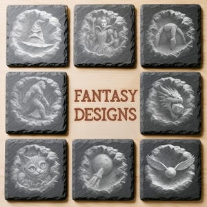 May include: A set of eight square dark gray slate coasters featuring engraved fantasy imagery including a wizard hat, a queen, a spider, a creature, a dragon with a die, a cat, a moon with a rocket, and a winged ball, with the text FANTASY DESIGNS.
