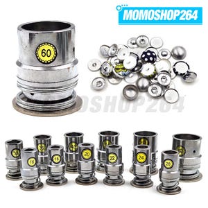 May include: A collection of silver-colored metal button-making dies and various fabric-covered button components. The dies are marked with numerical labels including 16, 18, 20, 22, 24, 28, 32, 36, 40, and 60. The text MOMOSHOP264 appears in the corner.