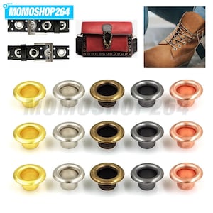May include: A collection of metal grommets in five distinct finishes including gold, silver, antique brass, gunmetal, and copper. These circular eyelets are arranged in three horizontal rows, showcasing their smooth, hollow, and flanged design.