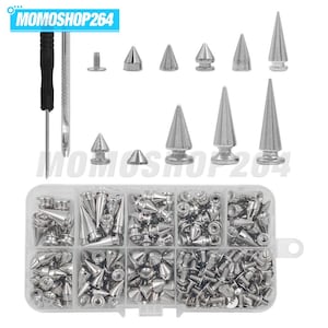 May include: A collection of silver-toned metal cone studs and spikes in various sizes, accompanied by a black-handled screwdriver and a metal punch tool. The hardware is organised in a clear, rectangular plastic storage box with eight compartments.