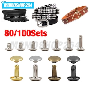 May include: A collection of metal rivets in gold, silver, bronze, and gunmetal finishes, shown with examples of a black leather cap, a studded black leather belt, and a brown leather collar. The text 80/100Sets and MOMOSHOP264 are visible.