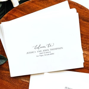 May include: A stack of white envelopes with calligraphy writing on the front. The text reads "Deliver to Jessica and John Thompson 34657 N 84th St Las Vegas, Nevada 88901". The text on the second envelope reads "Jessica and Thomas 2146 Red Oak Lane Liberty, MO 81608". The text at the bottom of the image reads "Add on: with purchase of our invitations only".