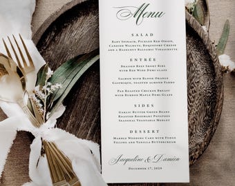 May include: A white rectangular menu card with dark green text featuring sections for salad, entree, sides, and dessert, with the names Jacqueline & Damien and the date December 17, 2029, printed at the bottom in a formal script font.