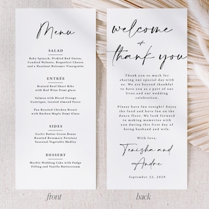 May include: A white rectangular wedding menu and thank you card set with black serif and script typography. The front lists salad, entree, sides, and dessert options. The back features a welcome and thank you message signed by Tenisha and Andre.