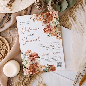 May include: A wedding invitation with floral accents in shades of orange, peach, and cream. The invitation features the names "Delanie and Samuel" in elegant script, along with event details. The invitation is surrounded by decorative flowers and greenery.