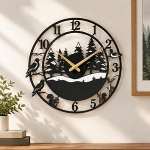 May include: A round black wall clock featuring a forest scene with pine trees, a snowy landscape, and silhouettes of birds, a squirrel, and a deer. The clock has gold-colored hands and large black numerals from one to twelve.