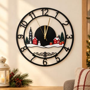 May include: A circular black wall clock featuring large cut-out numbers from 1 to 12. The center displays a winter scene with a church, red houses, green pine trees, a snowman, and gift boxes on a snowy landscape with gold clock hands.