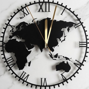 May include: A circular wall clock featuring a black metal frame with Roman numerals and a silhouette of a world map in the center. The clock has two thin gold-colored hands and a central gold-colored post, creating a contrast against the dark map.