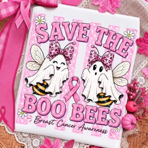 May include: A white rectangular sign featuring the text SAVE THE BOO BEES Breast Cancer Awareness in pink bubble letters. The design includes two ghost bees wearing pink leopard print bows, a pink awareness ribbon, and small white daisies.