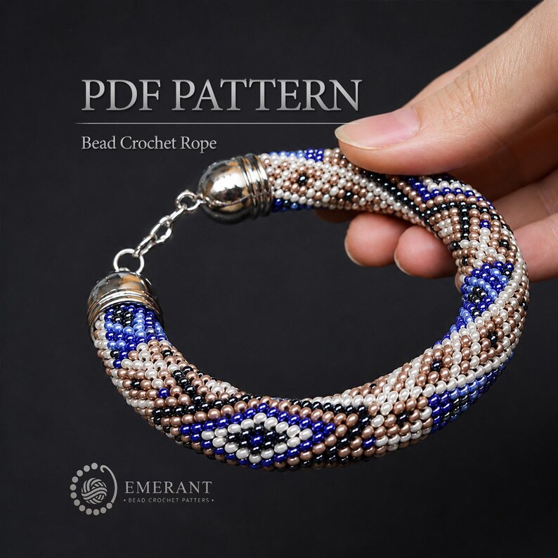 May include: A bead crochet rope bracelet featuring a geometric pattern in blue, white, and metallic bronze seed beads. The bracelet has silver-toned metal end caps and a chain link clasp. Text reads PDF PATTERN Bead Crochet Rope and EMERANT.