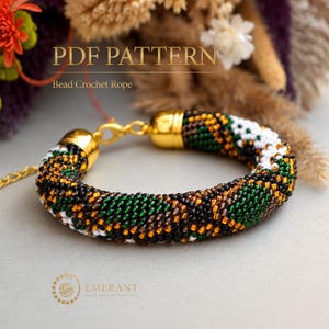 May include: A bead crochet rope bracelet featuring a geometric pattern of black, green, white, and amber beads. The bracelet includes gold-toned metal end caps and a lobster clasp closure. The text PDF PATTERN Bead Crochet Rope is visible.