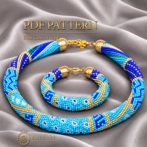 May include: A PDF pattern for a bead crochet rope necklace and bracelet set. The jewellery features a geometric pattern in shades of blue, turquoise, white, and gold beads, finished with gold-toned metal end caps and lobster claw clasps.