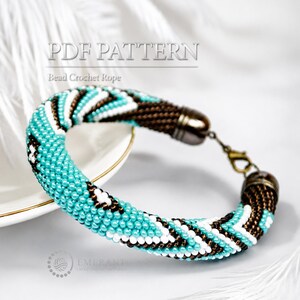 May include: A bead crochet rope bracelet featuring a geometric pattern in turquoise, white, and dark brown seed beads. The bracelet includes metallic end caps and a lobster claw clasp. The text PDF PATTERN Bead Crochet Rope is visible.