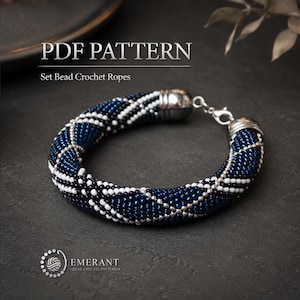 May include: A bead crochet rope bracelet featuring a geometric pattern of dark blue, white, and silver beads. The bracelet includes silver-toned metal end caps and a lobster claw clasp. Text reads PDF PATTERN Set Bead Crochet Ropes.