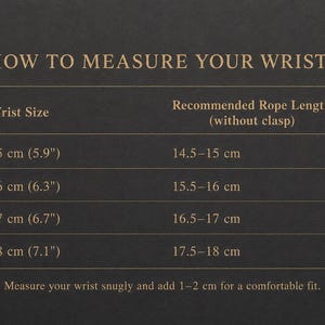 May include: A dark grey informational chart titled HOW TO MEASURE YOUR WRIST with gold text. It lists wrist sizes from 15 cm (5.9 inches) to 18 cm (7.1 inches) and corresponding recommended rope lengths without a clasp, plus measurement instructions.