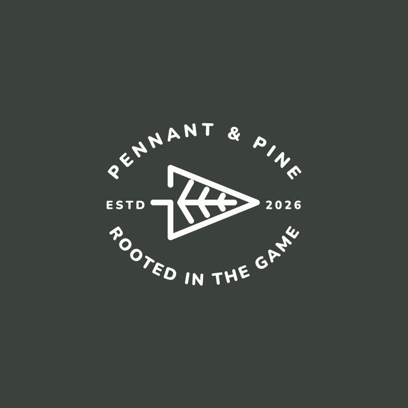 May include: A white logo on a dark green background. The logo features the text "PENNANT & PINE" in a circular arrangement, with "ESTD 2026" and "ROOTED IN THE GAME" also in a circular arrangement. A white arrow-shaped design is in the center.