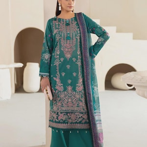 May include: A teal long-sleeved tunic featuring intricate pink and white floral embroidery, paired with matching wide-leg trousers with a scalloped hem and a sheer teal dupatta with a decorative border, creating a coordinated three-piece outfit.