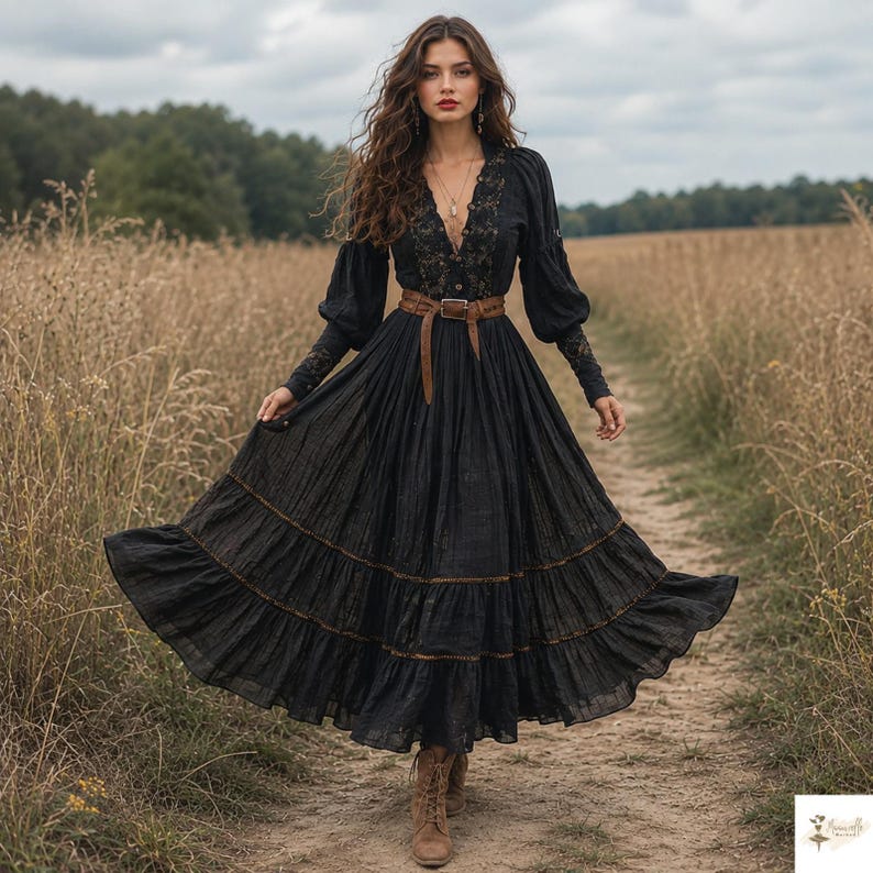 May include: A long-sleeved black dress featuring a deep V-neckline with intricate black lace detailing, a fitted bodice, a brown leather belt with a metal buckle at the waist, and a full, tiered skirt with subtle brown stitching along the hem.