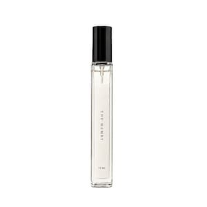 May include: A tall, slender, clear glass perfume bottle with a black cylindrical cap and a spray nozzle. The white label on the front features the text THE MEMRY and 10 ML in black font. The bottle contains a clear liquid and has a rectangular shape.