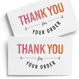 May include: Two rectangular white cards featuring the text THANK YOU in a pink to orange watercolor gradient font. Below this, the word for is written in black script, followed by the text YOUR ORDER in black capital letters with decorative flourishes.
