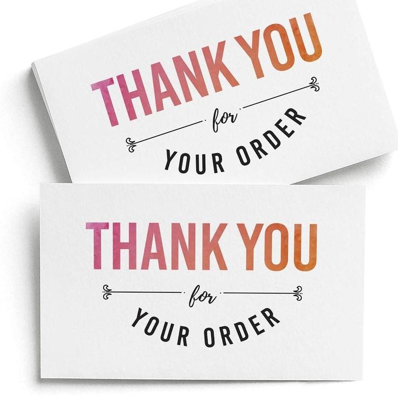 May include: Two rectangular white cards featuring the text THANK YOU in a pink to orange watercolor gradient font. Below this, the word for is written in black script, followed by the text YOUR ORDER in black capital letters with decorative flourishes.