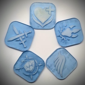 May include: Five square, light blue translucent tiles featuring raised white symbols. The icons include a heart with a cross, crossed swords, a paw print, a cracked shield, and a single wing, all arranged in a circular pattern on a white background.