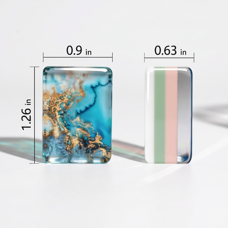 May include: Two rectangular glass cabochons. The left piece features a blue and gold marbled pattern measuring 0.9 inches wide by 1.26 inches high. The right piece has vertical stripes of white, sage green, and pale pink, measuring 0.63 inches wide.