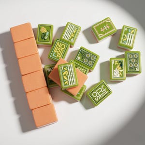 May include: A set of mahjong tiles featuring a vertical stack of six solid peach-colored tiles and several green tiles with various illustrations, including bamboo, circles, a peacock, and text such as NORTH, WEST, EAST, and SOUTH in white.