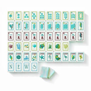 May include: A set of white mahjong tiles featuring teal and brown illustrations of marine life, tropical plants, bamboo, and Chinese characters. The tiles include numbered suits, joker tiles with various icons, and tiles spelling the word NEWS.