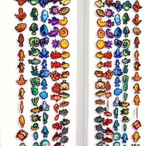 May include: Two vertical wall hangings featuring pixel art fish and sea creatures in various colours. Each hanging is topped with a wooden sign displaying the Chinese characters 上钩了. The colourful pixelated figures are arranged in columns.