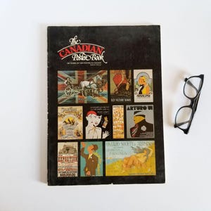 May include: A black book titled "The Canadian Poster Book" with a collection of vintage posters from Canada. The posters feature various themes, including entertainment, war bonds, and art exhibitions.