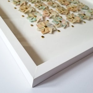 A close up of the bottom left corner of the shadow box frame.