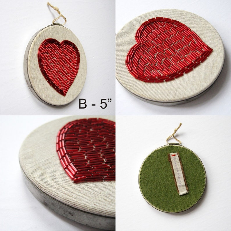 May include: A set of three embroidered heart-shaped ornaments. The ornaments are 5 inches in diameter and feature a red beaded heart design on a white linen background. One ornament has a green felt backing.