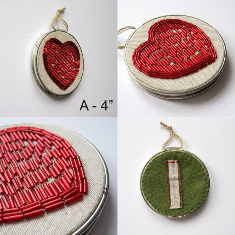 May include: A set of four 4-inch round embroidery hoops with red beaded hearts. The hoops are made of metal and have a white fabric backing. One hoop has a green felt backing with a handwritten message.