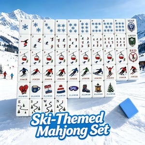 May include: A white mahjong set featuring ski-themed illustrations including snowflakes, skiers, red cable cars, and winter accessories. The tiles display numbers one through nine, joker labels, and flower icons, with a separate blue rectangular tile.