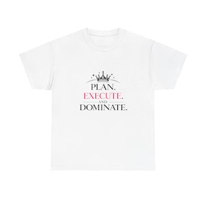 May include: White t-shirt with the text "PLAN. EXECUTE. AND DOMINATE." in black and pink, topped with a crown graphic. The shirt is a casual wear item.