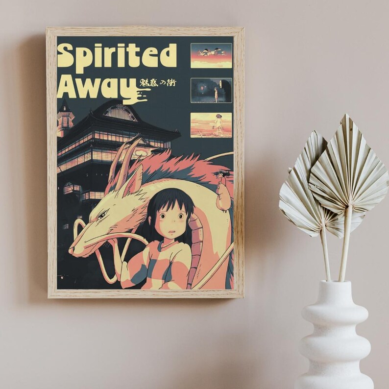 May include: A framed poster featuring the title Spirited Away in yellow text, with a dark blue background showing a large dragon, a young person, and three smaller rectangular scenes. The artwork depicts a traditional building and characters.