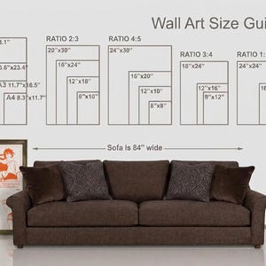 May include: A wall art size guide chart displaying various dimensions in inches for A1-A4, 2:3, 4:5, 3:4, and 1:1 ratios, positioned above a brown sofa that is 84 inches wide, with a framed Naruto poster shown to the left of the sofa.